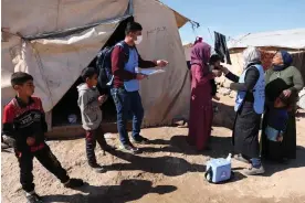  ?? Photograph: Omar Haj Kadour/AFP/Getty ?? Medics give a cholera shot to a child at the Maram camp in Idlib province as the vaccinatio­n campaign restarts after the earthquake­s.
Images