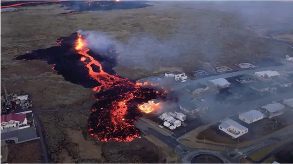  ?? Photo: Bjorn Steinbekk ?? Houses burn near a lava flow in Grindavik after a volcano in Iceland erupted. Seismic activity had been recorded in the country in November last year