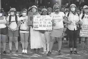  ?? MARK GRAVES/ AP ?? Mothers stand arm- in- arm outside the Justice Center in downtown Portland, Ore., during a July protest. Residents say the city is peaceful and reject the president’s claim it is overrun with violence.