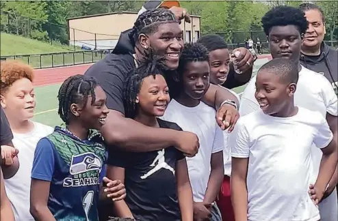  ?? Sean Patrick Bowley / Hearst Connecticu­t Media ?? New Haven’s Tyler Booker, who will play football at Alabama, returned this past weekend to offer a one-day football camp at Bowen Field.