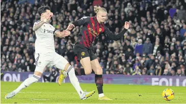  ?? REUTERS ?? Manchester City’s Erling Braut Haaland, right, scores their second goal against Leeds United at Elland Road.