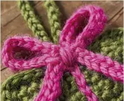  ??  ?? Wrap a length of excess yarn around the centre of the crocheted bow to help keep it in shape.