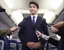  ??  ?? Turbulence: Trudeau talks to reporters on his plane