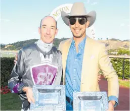  ?? Photo / Race Images ?? Trainer Chad Ormsby (right) and jockey Warren Kennedy after winning the New Zealand Oaks at Trentham yesterday.