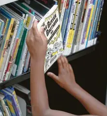  ??  ?? Some children tell bookmobile staffers that “our library is closed, so we haven’t been to the library in a while.”