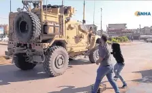  ?? ANHA/ASSOCIATED PRESS ?? Residents who are angry over the U.S. withdrawal from Syria hurl potatoes at American military vehicles in the town of Qamishli, northern Syria, Monday.