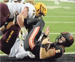  ?? STEVE DYKES/AP ?? Oregon State quarterbac­k Jake Luton (6) is sacked by Arizona State defensive linemen Jermayne Lole and Roe Wilkins during the first half in Corvallis, Ore., Nov. 16.