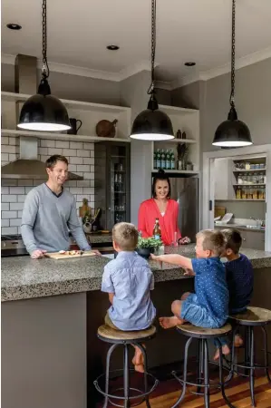  ??  ?? RIGHT On Saturday mornings, you’ll find the family at the breakfast bar, with the boys squabbling over who’ll get the biggest of Simon’s warm homemade pancakes. Behind them, bevelled white gloss subway tiles from Tile Depot, paired with black grout,...