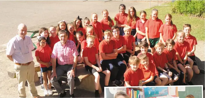  ??  ?? A group of pupils with Principal, Danny Gallagher (left) and Harry Marron who is retiring from his teaching post at Dulargy National School, Ravensdale after 40 years of service.