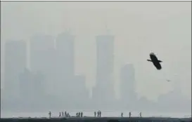  ?? SATYABRATA TRIPATHY/HT PHOTO ?? The city’s skyline was hardly visible from Mahim on Monday. Pollution levels are likely to remain in the ‘poor’ category today, too, with SAFAR predicting an AQI of 201.