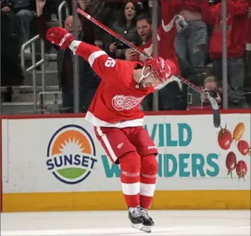  ?? Paul Sancya/Associated Press ?? Detroit’s Jake Walman shows off a few dance moves after scoring on a penalty shot to beat Vancouver Saturday in overtime.