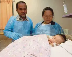  ??  ?? Japlee Pangiran (left) and Joy Supang Barok with their son Terrence Hazekiel Japlee.