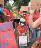  ?? SPENCER PLATT/GETTY IMAGES ?? Teachers, parents and students march through Brooklyn, N.Y., on Sept. 1 to demand safety in schools.