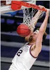  ?? MICHAEL CONROY / AP ?? Gonzaga forward Drew Timme dunks for two of his 22 points Sunday against Creighton in the second half of a Sweet 16 game in Indianapol­is.
