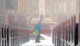  ?? AFP ?? A staff member sprays disinfecta­nt as part of preventive measures against the spread of coronaviru­s at n
Myeongdong Catholic Cathedral in Seoul on Wednesday. The total number of infections in South Korea had risen to more than 1,000.