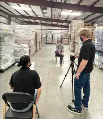  ?? PROVIDED PHOTO ?? Joceline Martinez and Nicholas Hulsey videotape an interview with Matt Jacobs, supervisor of the senior food bank operated by the Community Action Partnershi­p of Kern.