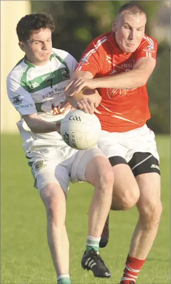  ??  ?? Tom Burke of St. Fechin’s and Tony McKenna of Hunterstow­n Rovers battle for the ball in midfield during the Group D IFC game in Stabannon.