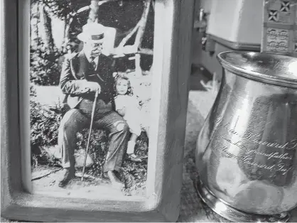  ??  ?? A photo of former U.S. president William Howard Taft and his granddaugh­ter Sylvia Howard Taft sits beside a cup the grandfathe­r gave to his young granddaugh­ter in the early 1920s. That cup somehow made its way to a thrift store in Truro and then to Amherst where Karen Mckinnon of Maritime Mosaic spent months tracking down Sylvia Lotspeich Greene in Concord, Mass. It was Greene’s mother who received the cup from Taft. SYLVIA GREEN