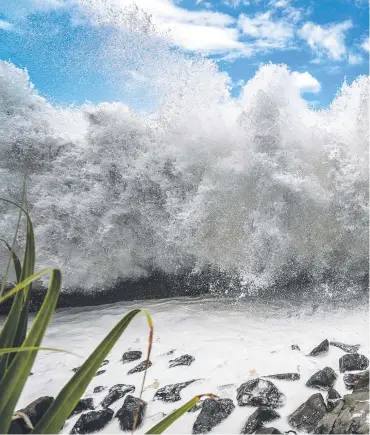  ?? Picture: NIGEL HALLETT ?? Teens flirt with danger as the huge waves generated by Cyclone Oma hit the Gold Coast.