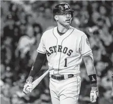  ?? Karen Warren / Staff photograph­er ?? Carlos Correa heads back to the dugout after striking out swinging in the sixth inning. Correa went 1-for-5 with three strikeouts Tuesday night.