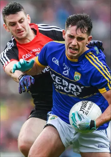  ??  ?? Jack Savage of Kerry is challenged by Brendan Harrison of Mayo. The sides served up a decent All-Ireland semi-final on Sunday.