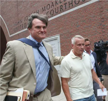  ?? Herald StaFF File ?? NO JUSTICE: Retired Massachuse­tts State Trooper Darren DeJong, right, exits Moakley Federal Court with his lawyer in 2018.