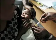  ?? KAREL PRINSLOO — THE ASSOCIATED PRESS FILE ?? A mother holds her baby receiving a new malaria vaccine as part of a trial at the Walter Reed Project Research Center in Kombewa in Western Kenya, in 2019.