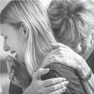  ?? STUART VILLANUEVA / THE GALVESTON COUNTY DAILY NEWS VIA THE ASSOCIATED PRESS ?? Santa Fe High School student Dakota Shrader is comforted by her mother Susan Davidson following a shooting at the school on Friday in Santa Fe. Shrader said her friend was shot in the rampage.