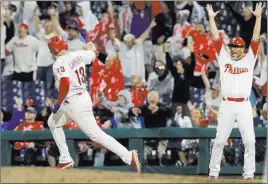  ?? Matt Slocum ?? The Associated Press Asdrubal Cabrera celebrates his walk-off home run with Phillies first-base coach Jose Flores in the 10th inning of Philadelph­ia’s 2-1 win over the Cubs on Friday.