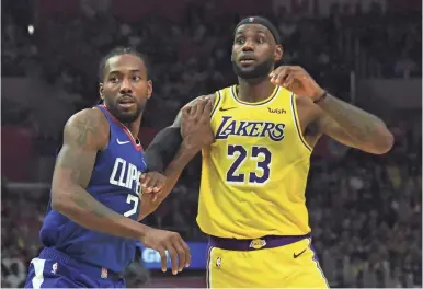  ??  ?? LeBron James and the Lakers hope to avenge on Christmas Day an openingnig­ht 112-102 loss to Kawhi Leonard and the Clippers.