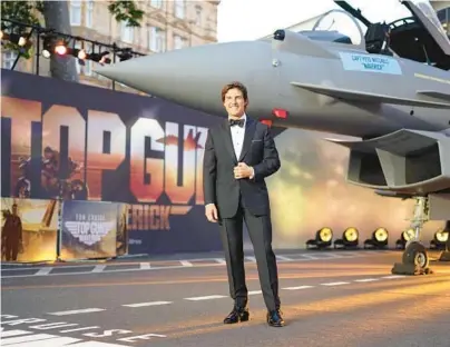  ?? ALBERTO PEZZALI/AP 2022 ?? Blast from the past: Tom Cruise suits up for the“Top Gun: Maverick”U.K. premiere last spring at a London cinema.