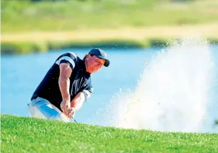  ?? AFP ?? Phil Mickelson of the US Team plays a shot from a bunker on the 14th hole. —