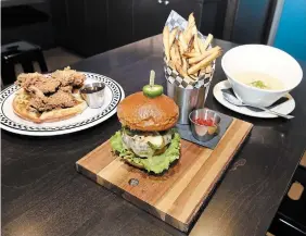  ?? GRAHAM PAINE METROLAND FILE PHOTO ?? This photo, taken shortly before Studebaker’s February 2019 opening, features chicken and waffles, a Studebaker burger with hand cut fries and East Coast clam chowder.