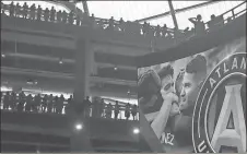  ?? Paul Newberry / The Associated Press ?? Fans watch the MLS match of local Atlanta United and FC Dallas on Sunday to inaugurate the team’s play in the new Mercedes-Benz Stadium.