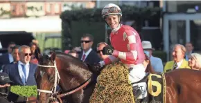  ?? GETTY IMAGES ?? Jockey Flavien Prat, aboard Rombauer, celebrates in the winners circle after winning the 146th Preakness Stakes in Baltimore.