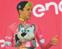  ?? DANIEL DAL ZENNARO/ANSA VIA AP ?? Britain’s Simon Yates, wearing the pink jersey of the overall leader, celebrates Tuesday on the podium at the end of the 16th stage of the Giro d’Italia cycling race. The British cyclist is still in control of the Giro d’Italia after limiting his...