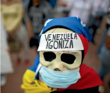  ?? PHOTO: AP ?? A woman dressed in a death costume that reads ‘‘Venezuela suffers’’ takes part in a protest over the country’s health crisis in Caracas yesterday.