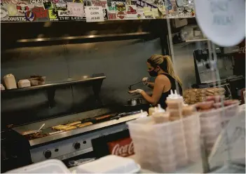  ?? KRISTEN ZEIS/STAFF ?? Tarah Morris, owner of Perfectly Frank, prepares orders at Perfectly Frank in Norfolk on Oct. 6.