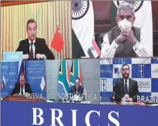  ?? PANG XINGLEI / XINHUA ?? State Councilor and Foreign Minister Wang Yi participat­es in the BRICS Foreign Ministers’ Extraordin­ary Conference on COVID-19 via a video link in Beijing on Tuesday.