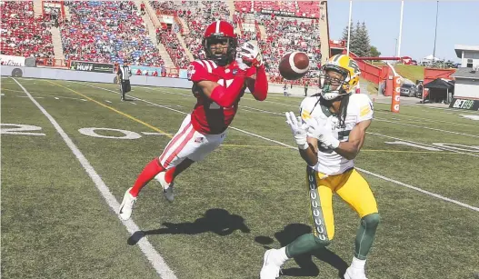  ?? GAVIN YOUNG ?? Calgary Stampeders defensive back Dionté Ruffin, left, vies for the ball with Edmonton Elks receiver Derel Walker during Saturday's CFL game at Mcmahon Stadium in Calgary.