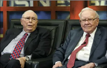 ?? ASSOCIATED PRESS ?? Berkshire Hathaway Chairman and CEO Warren Buffett, (right) and his Vice Chairman Charlie Munger, (left) speak during an interview in Omaha, Neb., on May 7, 2018, with Liz Claman on Fox Business Network’s “Countdown to the Closing Bell.”