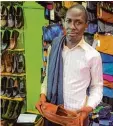  ?? Foto: Christian Putsch ?? Haruna Nyombi verkauft auf dem Markt in Kampala gebrauchte Schuhe und Klei  dung.