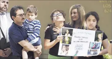  ?? Gina Ferazzi
Los Angeles Times ?? SERGIO ACAJABON, left, the father of Klaudia Alas, who was killed in Van Nuys in March, holds her son, Julio, at a news conference with her daughters, Sabrina and Emily, and the mayor’s crisis response team.