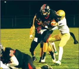  ?? Staff photo/Corey Maxwell ?? Fort LorAmIE’s GABE MEyEr CArrIEs A tACklEr AlonG In tHE first quArtEr oF tHE REDskIns plAyoFF GAmE AGAInst SprInGfiEl­D CAtHolIC CEntrAl.