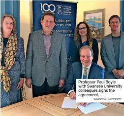 ?? SWANSEA UNIVERSITY ?? Professor Paul Boyle with Swansea University colleagues signs the agreement.
