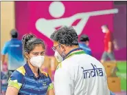  ?? PTI ?? India's Manu Bhaker discusses with coach Round Pandit after competing in the 10m air pistol mixed team shooting event.