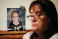  ?? MATT ROURKE - THE ASSOCIATED PRESS ?? Patti Burt poses for a portrait near a photo of her granddaugh­ter, 9-year-old Ava Lerario, in Cherry Hill, N.J., Wednesday, March 10, 2021. Burt’s daughter Ashley Belson, Ava, and Ava’s father, Marc Lerario, were found shot to death on May 26, 2020.