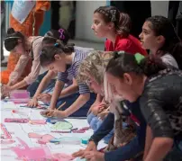  ?? AFP ?? Palestinia­n girls draw during a summer camp in Gaza City. —