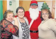  ??  ?? Santa’s here Jane Dunn, Jean Brown and Hazel Wenborne get their picture taken with the main man