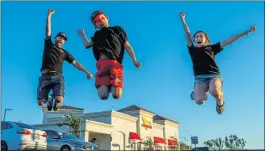  ?? PHOTOS BY TERRY PIERSON — STAFF PHOTOGRAPH­ER ?? Sam Vonderheid­e, left, and his kids Berkeley and Emery jump for joy Wednesday after completing their quest to eat at all 366In-N-Out Burger restaurant­s in the country, their last being on Van Buren Boulevard in Riverside.